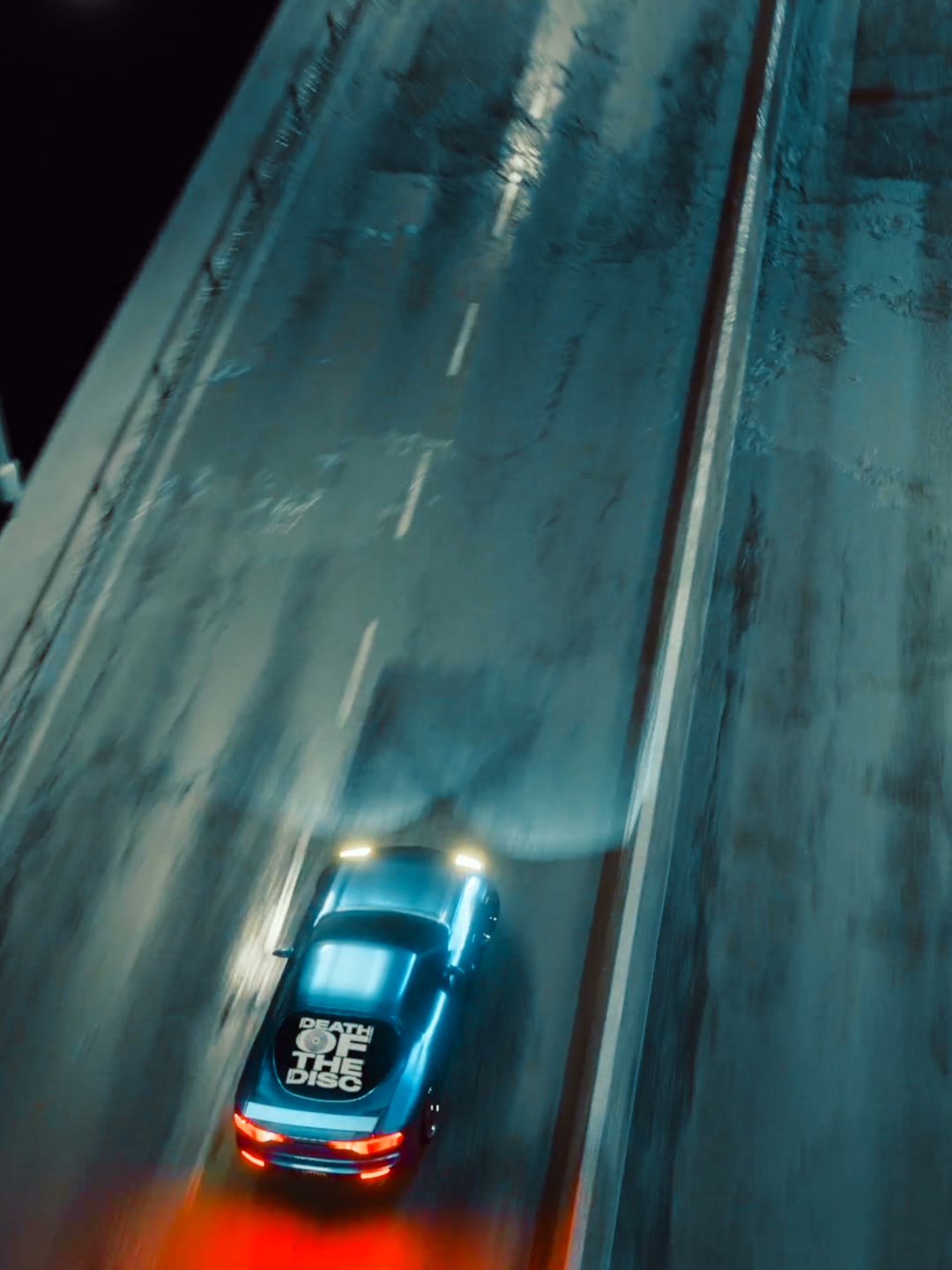 Overhead 3D render of a car racing down a wet freeway at night